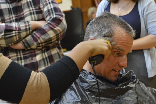 Students shave Bridgehampton School teacher John Reilly's head on Friday. ALYSSA MELILLO