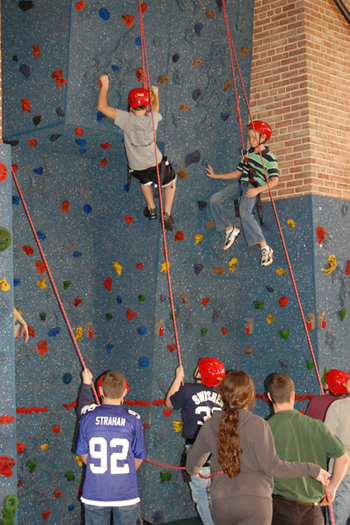 Principal shows rock climbing skills during wall dedication ceremony ...