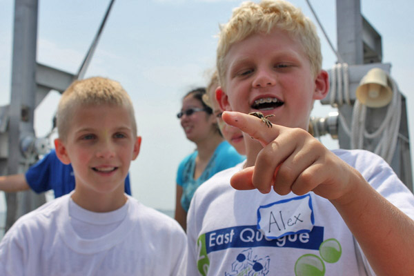 On the right, Alex Alford, 10, holds a crab during the East Quogue Elementary Ocean Explorers Camp. CAROL MORAN