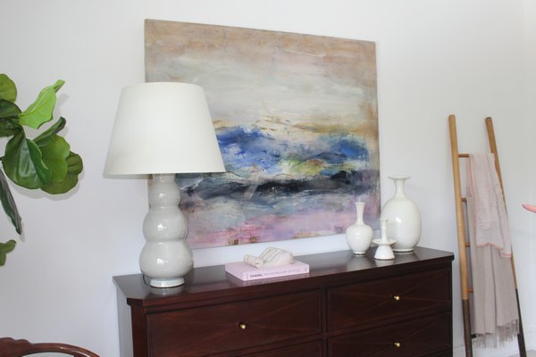 An abstract painting by East Hampton artist Anne Raymond is featured in the bedroom curated by Kate Singer Home.  JULIA HALSEY