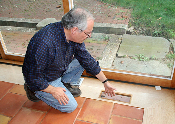 Bill Chaleff displays the air vents in his house. The house stays at 72 degrees the entire year.