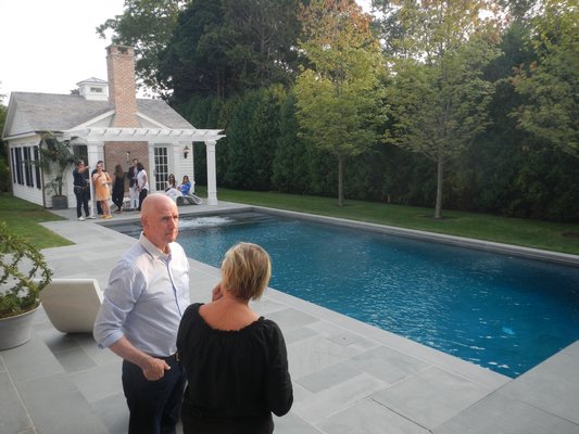 Guests gathered around the pool at the open house party for broker Tim Davis's first spec house. CAREY LONDON