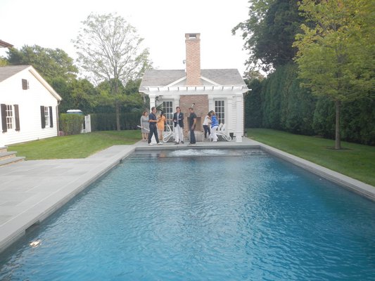 Guests gathered around the pool at the open house party for Tim Davis's first spec house. CAREY LONDON
