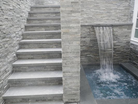 A second, more private, jacuzzi with a waterfall is accessible from the pool area via the stairs or from the finished basement. CAREY LONDON
