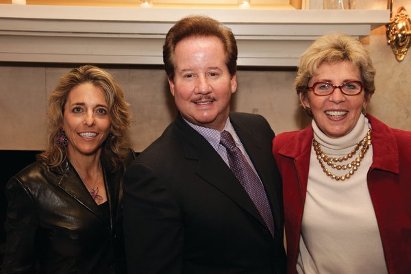 Pamela Liebman, Corcoran President and CEO, left, and Tresa Hall, Executive Vice President of Sales, awarded Tim Davis with a number of awards, including Top East End Agent. COURTESY THE CORCORAN GROUP
