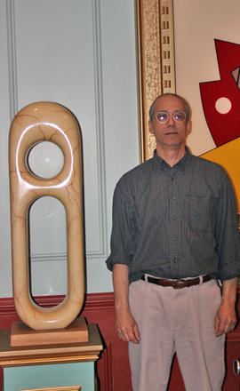 Manorville artist Joe Fratello stands with his artwork. JESSICA DINAPOLI