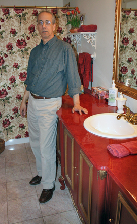 Manorville artist Joe Fratello in the bathroom at his Manorville home. JESSICA DINAPOLI