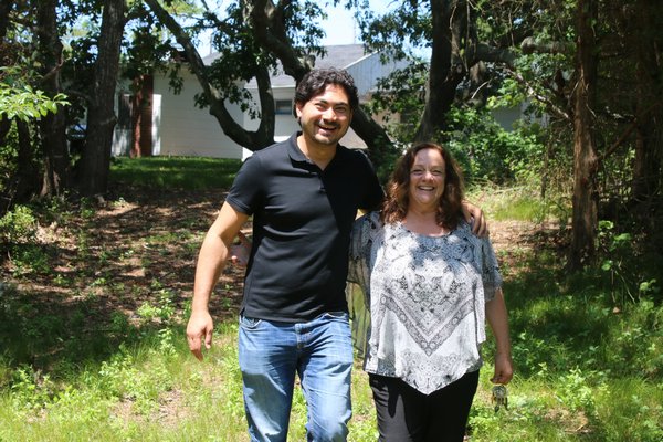 Ryunoske Jesse Matsuoka and Donna Lanzetta take a walk through Manna’s property where a fish hatchery is proposed. PEGGY SPELLMAN HOEY