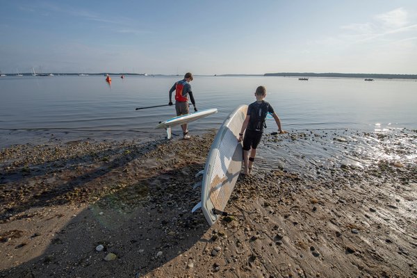 Sean and Liam Attebury walk to the water to paddle together for the very first time as father and son prior to the start of the annual Paddle for Pink at Havens Beach on Saturday morning.