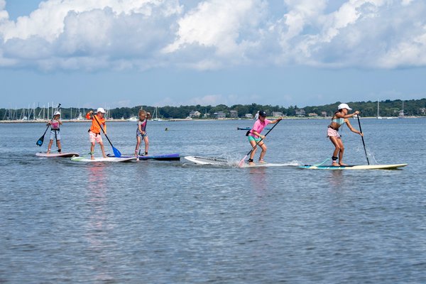 Kids participate in the children's paddleboard race during the annual Paddle for Pink at Havens Beach on Saturday morning.