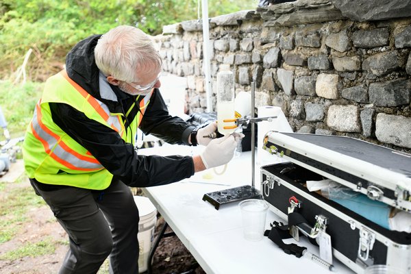 David Pinelli, left, senior scientist from Aecom, demostrates how the portable water treatment system works.   DANA SHAW