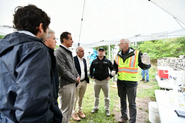 David Pinelli, left, senior scientist from Aecom, demostrates how the portable water treatment system works.   DANA SHAW