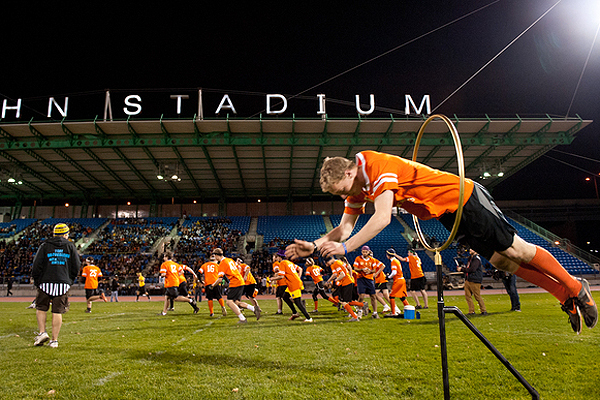A player jumps through one of the hoops before a Quidditch game. Photo by Jonathan Sanger.
