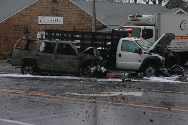 Passersby pulled the occupants of an SUV out of the vehilce shortly before it burst into flames following a head-on collision in Bridgehampton on Monday morning. Michael Wright