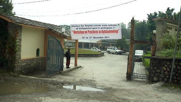 Entrance to the Himalayan Eye Hospital with the welcome banner.
