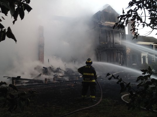 Firefighter battle a blaze in Sagaponack early Monday morning.