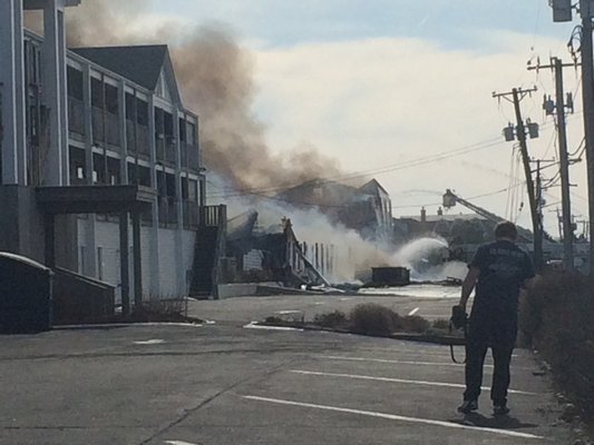 Firefighters battle a blaze in Westhampton Beach on Wednesday. KYLE CAMPBELL