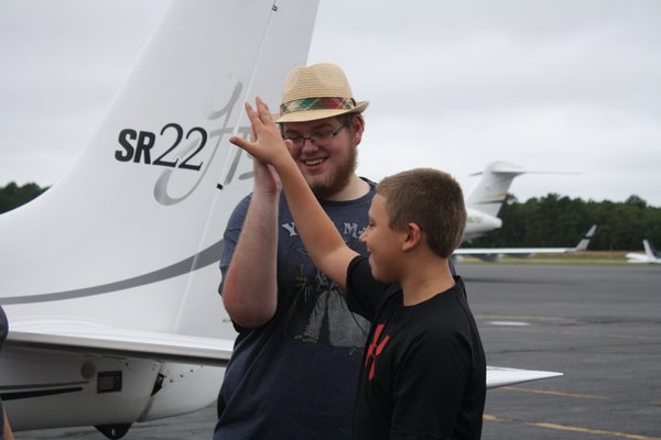  is greeted at East Hampton Airport on Saturday. He was one of 16 children and teens flown in from across the Northeast to attend the Kids Need More camp on Shelter Island. The camp caters to children with cancer and other life-threatening illnesses