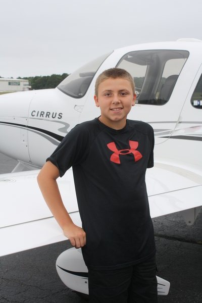  is greeted at East Hampton Airport on Saturday. He was one of 16 children and teens flown in from across the Northeast to attend the Kids Need More camp on Shelter Island. The camp caters to children with cancer and other life-threatening 