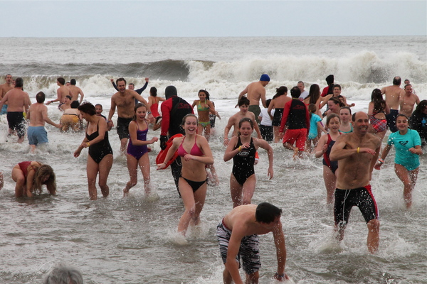 Swimmers wait for the start of the Polar Plunge at Atlantic Avenue Beach in Amagansett on Tuesday. KYRIL BROMLEY