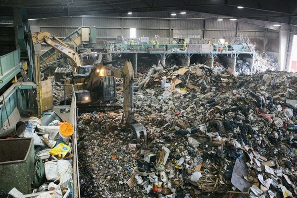 A team of four men is responsible for recovering any recyclables of value (mainly cardboard) from the waste stream at Paumanok Environmental in Yaphank. JOSEPH P. LOUCHHEIM