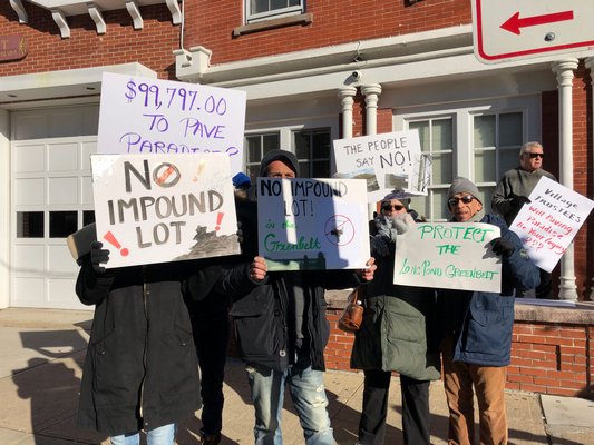 Concerned citizens in front of the Sag Harbor Municipal Building protesting the construction of an impound lot near the Long Pond Greenbelt .  COURTESY DAI DAYTON