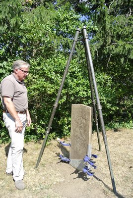 Tom Edmonds with one of the stones currently being repaired.  DANA SHAW