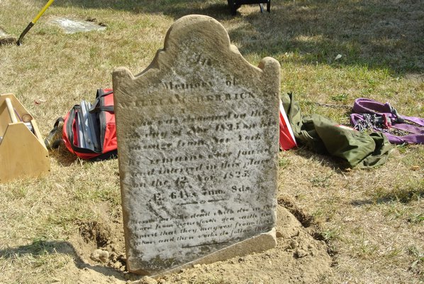 One of the repaired headstones in the North End Graveyard and Burial Ground in Southampton Village.  DANA SHAW