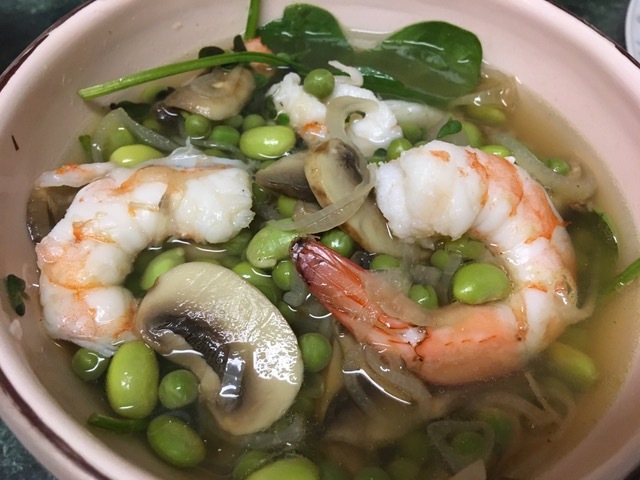 Shrimp with spinach, mushrooms, petit pois and edamame in lemongrass broth.