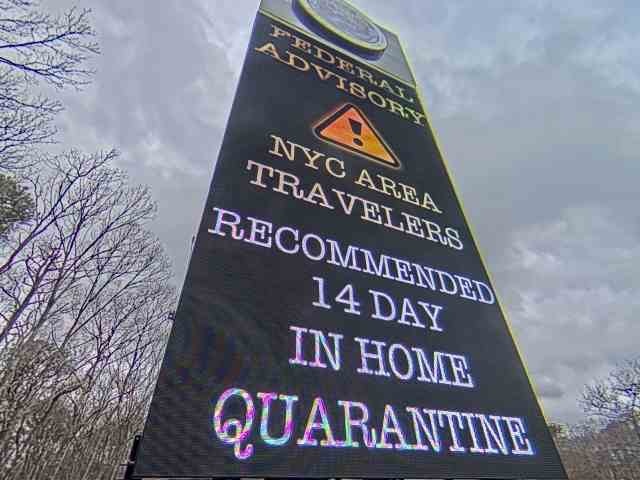 The Shinnecock Nation billboard carries the self-quarantine advisory.