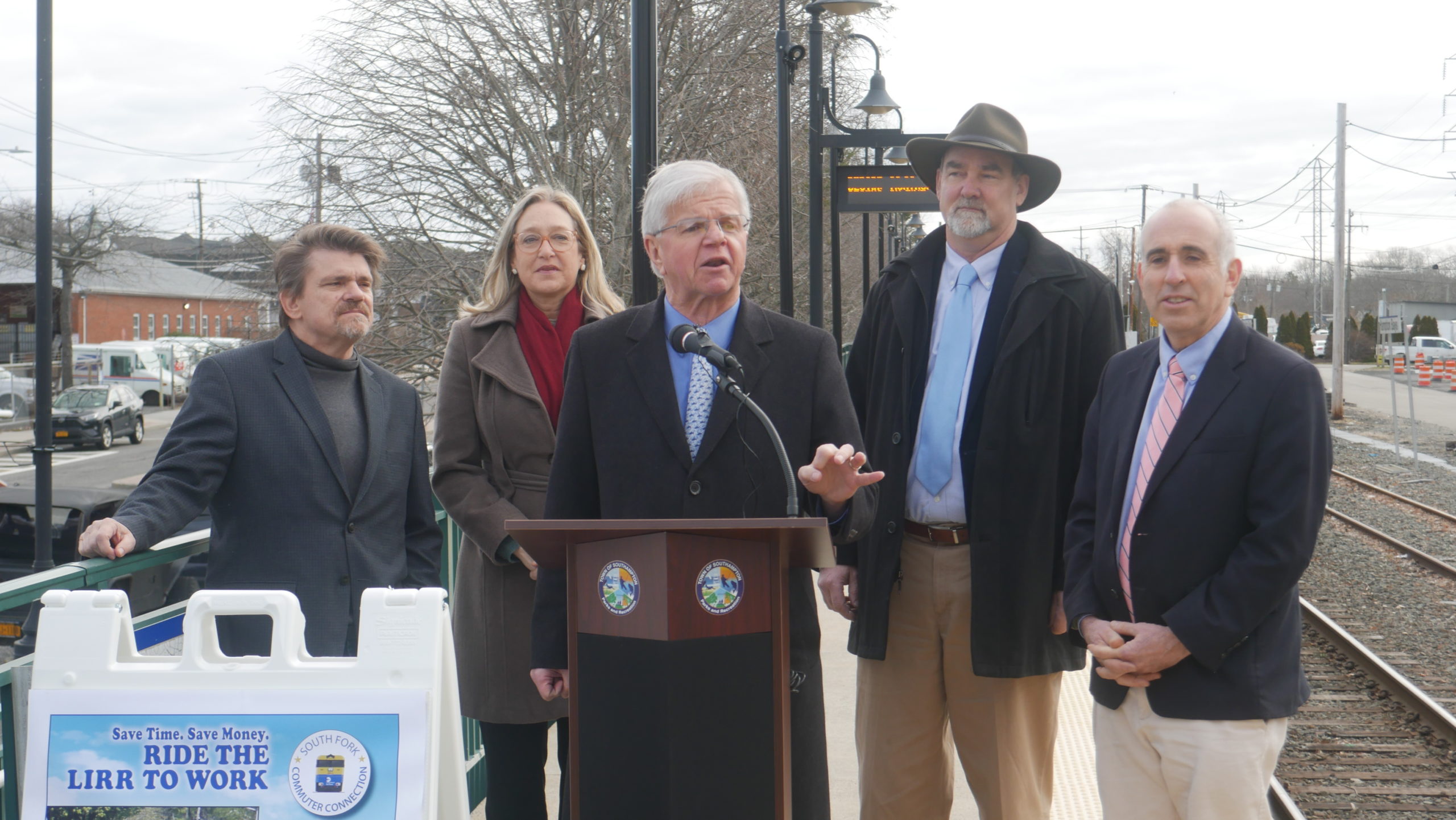 State Assemblyman Fred W. Thiele Jr. discusses the success of the South Fork Commuter Connection as Southampton Town Councilman Tommy John Schiavoni, Suffolk County Legislator Bridget Fleming, East Hampton Town Supervisor Peter Van Scoyoc, and Southampton Town Supervisor Jay Schneiderman look on. CONNIE CONWAY