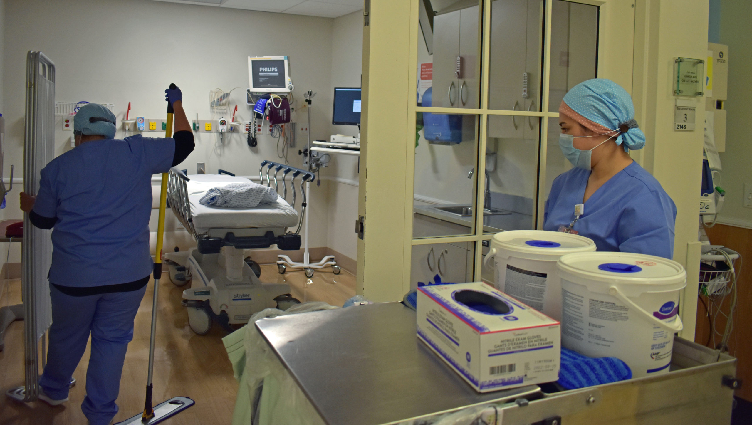 Ingrid Castillo, left, and Leslie Gettling working as environmental services housekeepers at Peconic Bay Medical Center in Riverhead.