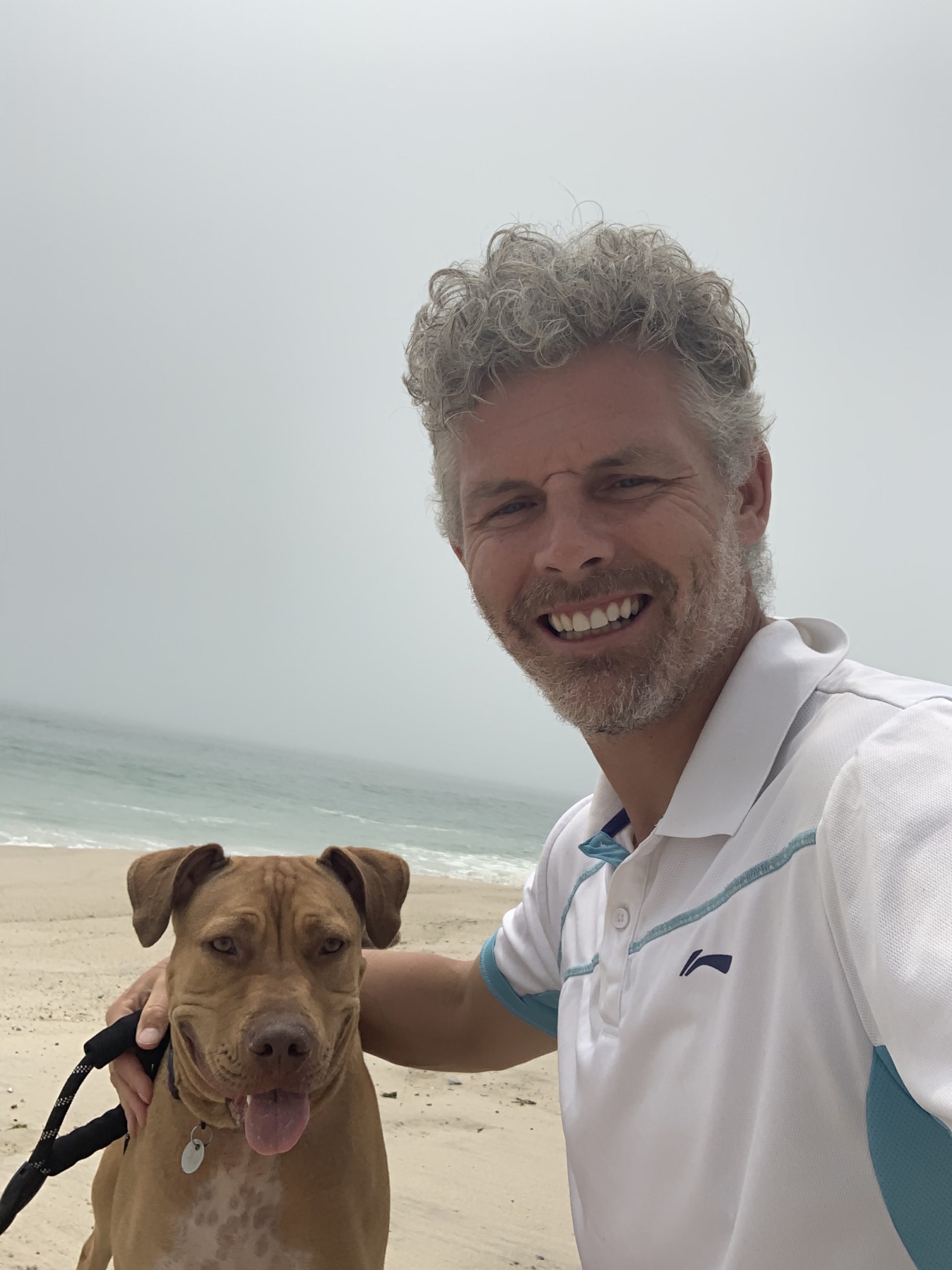 Des Bishop and his foster dog, Porsha, at the beach in West Hampton Dunes.