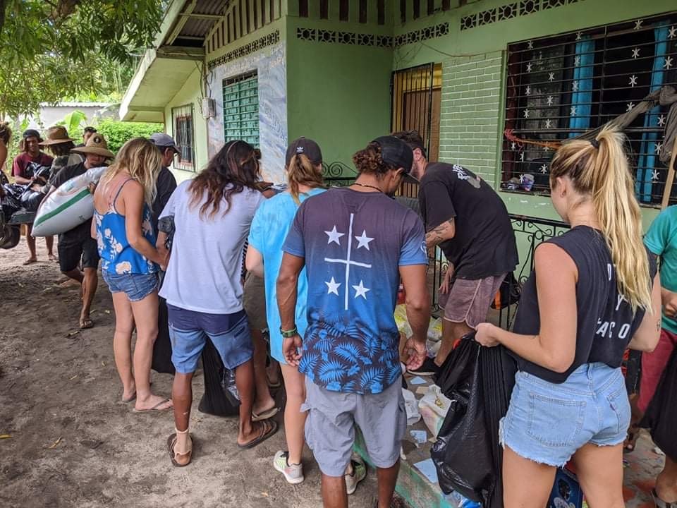 Volunteers from different communities help divide and repackage donations before distributing them to neighborhoods destroyed by hurricane flooding and high winds in Nicaragua.