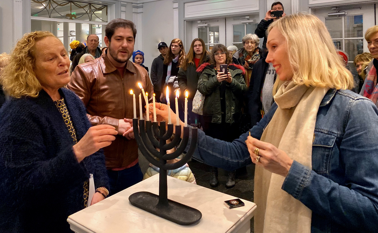 Guild Hall Executive Director Andrea Grover lights the menorah during last year's 