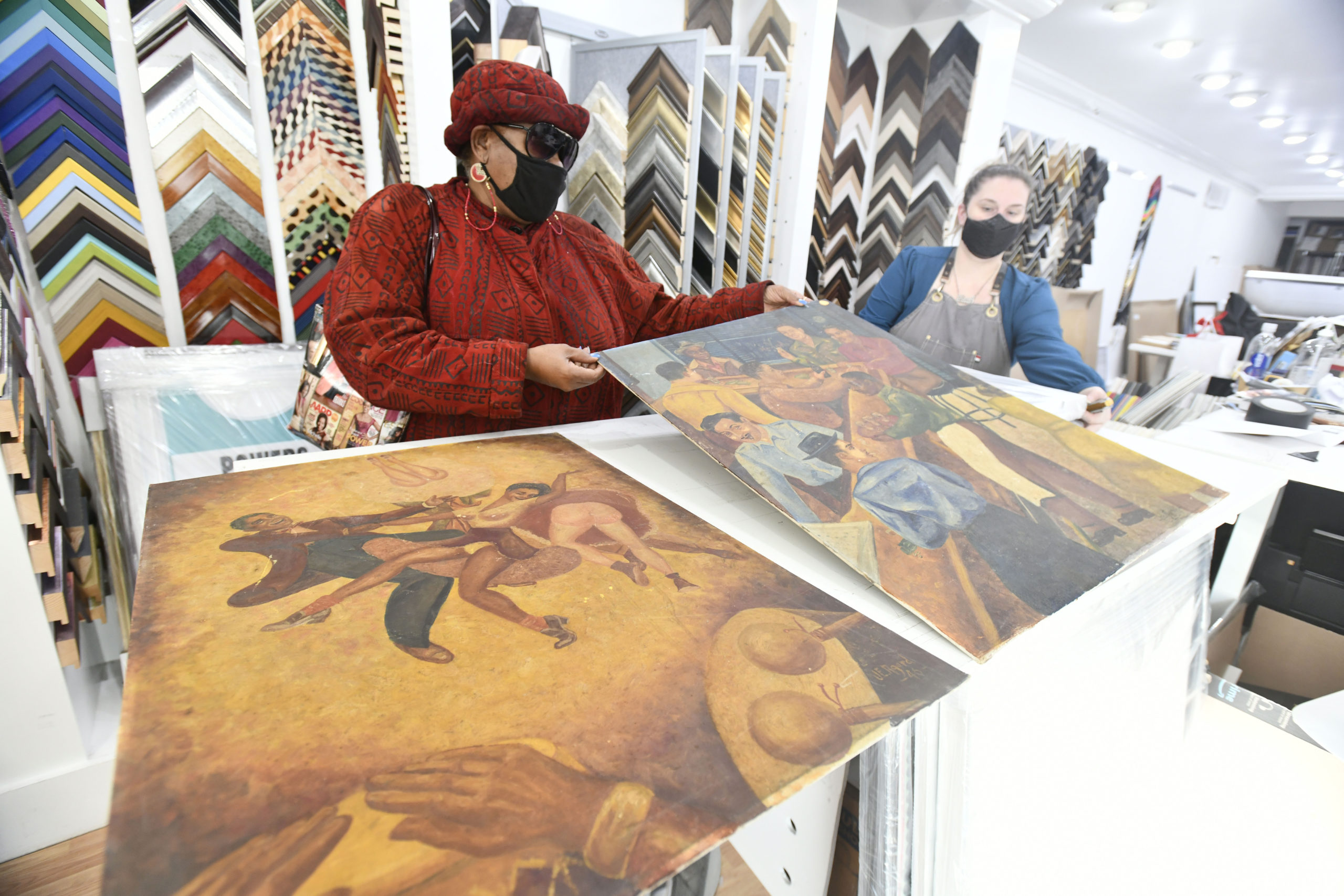 Brenda Simmons and Mary Godfrey with the Coal Bin paintings.  DANA SHAW