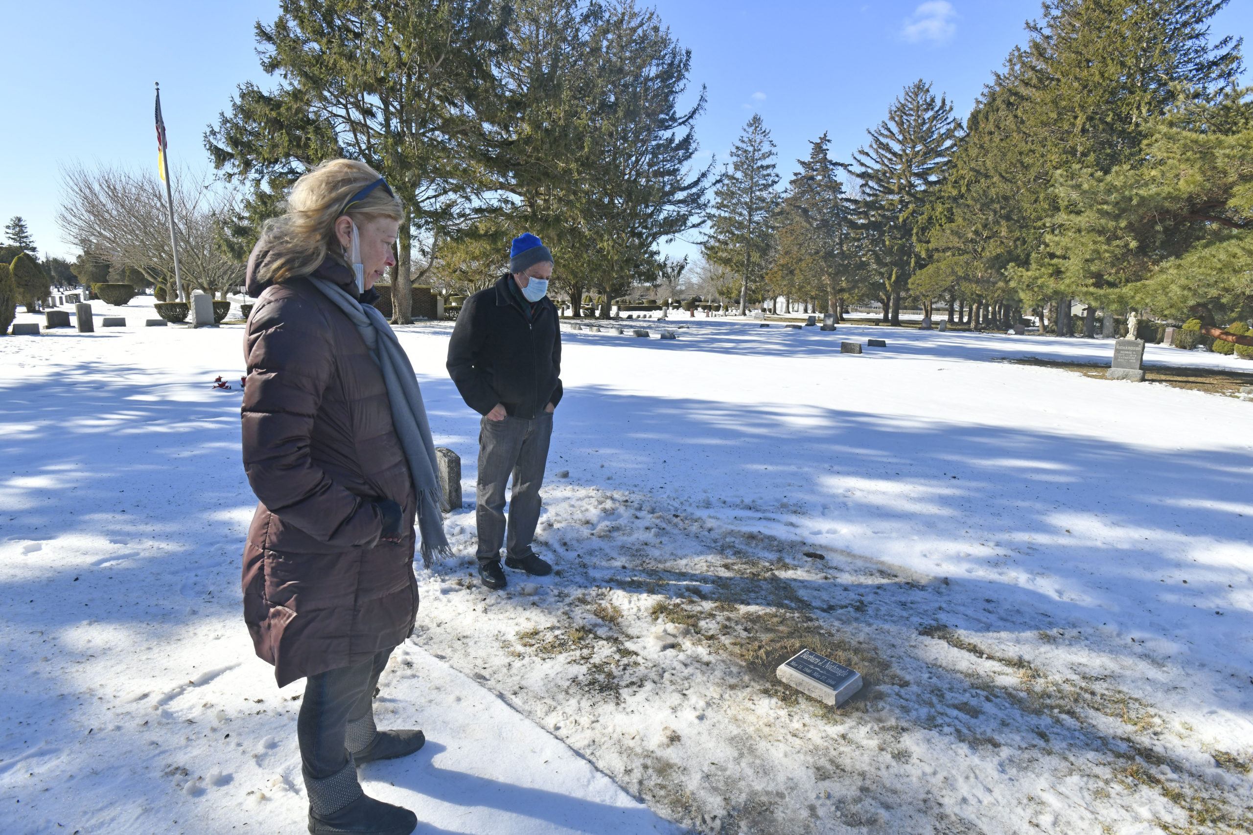 Janet O'Hare and her husband Scott at her sister's grave site  at the Southampton Cemetery on Thursday, February 4.    DANA SHAW