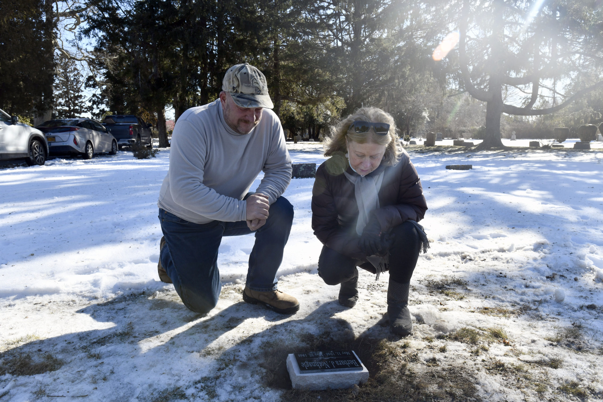 Southampton Cemetery Superintendent Eric Wright and Janet O'Hare at the grave site of O'Hare's sister, Barbara J. Nothnagle, on Thursday, February 4.      DANA SHAW