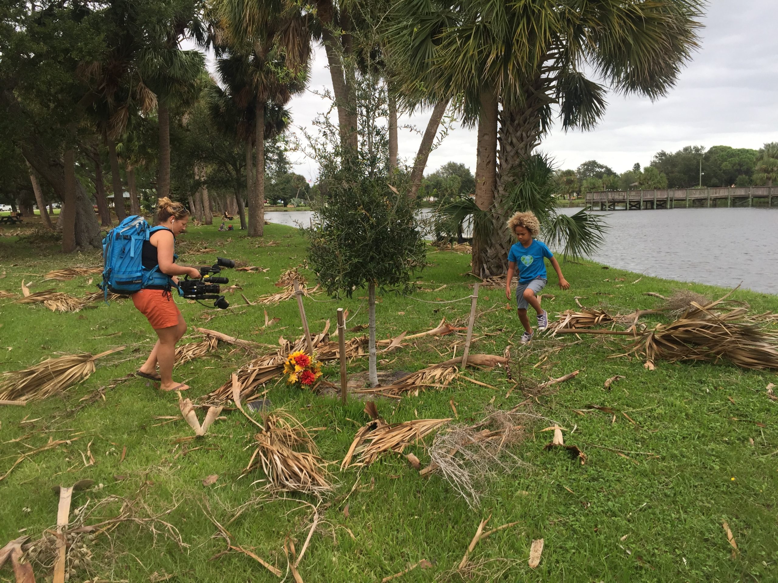 Christi Cooper filming Levi D., a plaintiff in the youth climate change case, near his Florida home after a storm.