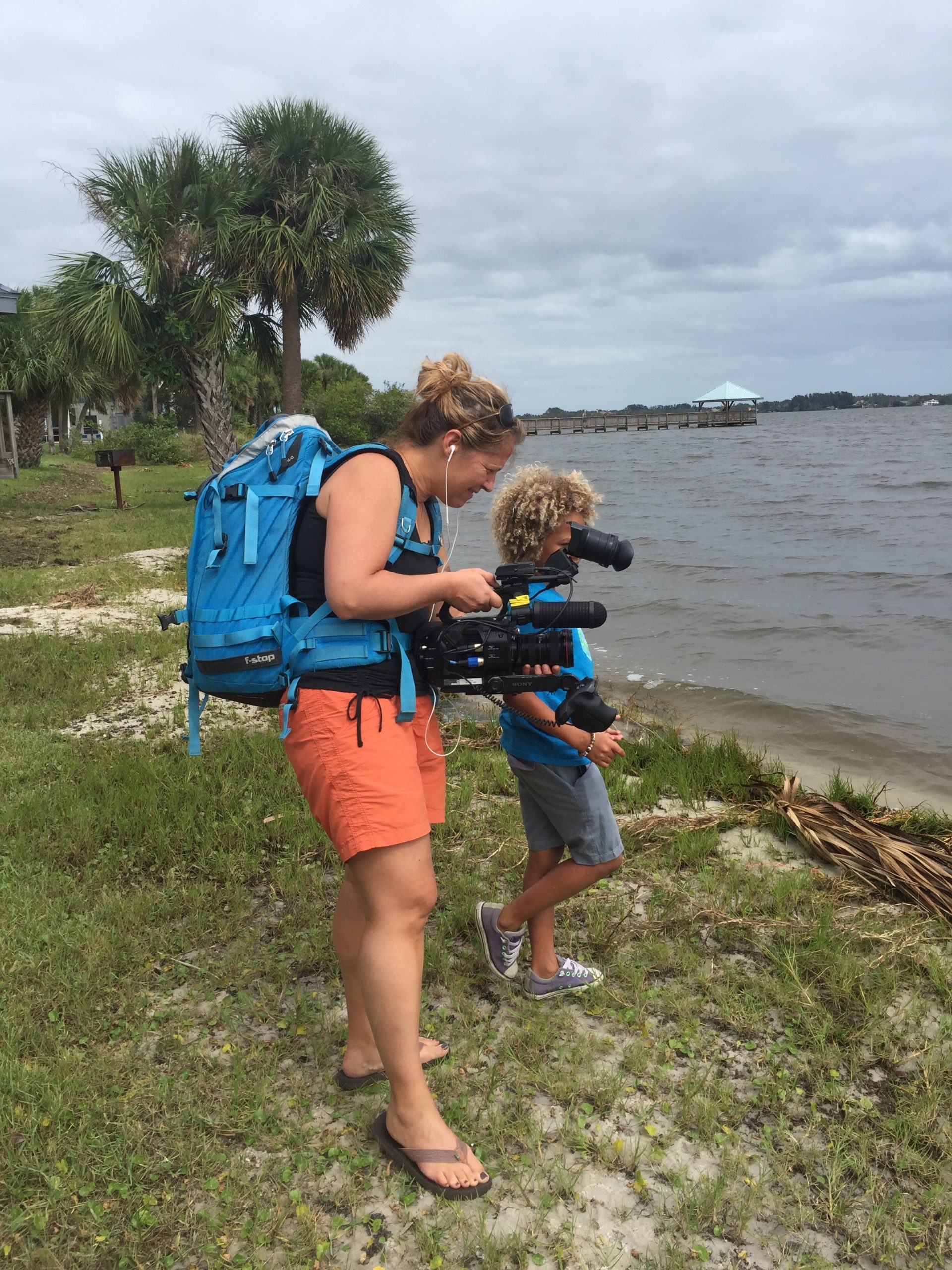 Christi Cooper filming Levi D., a plaintiff in the youth climate change case, near his Florida home after a storm.