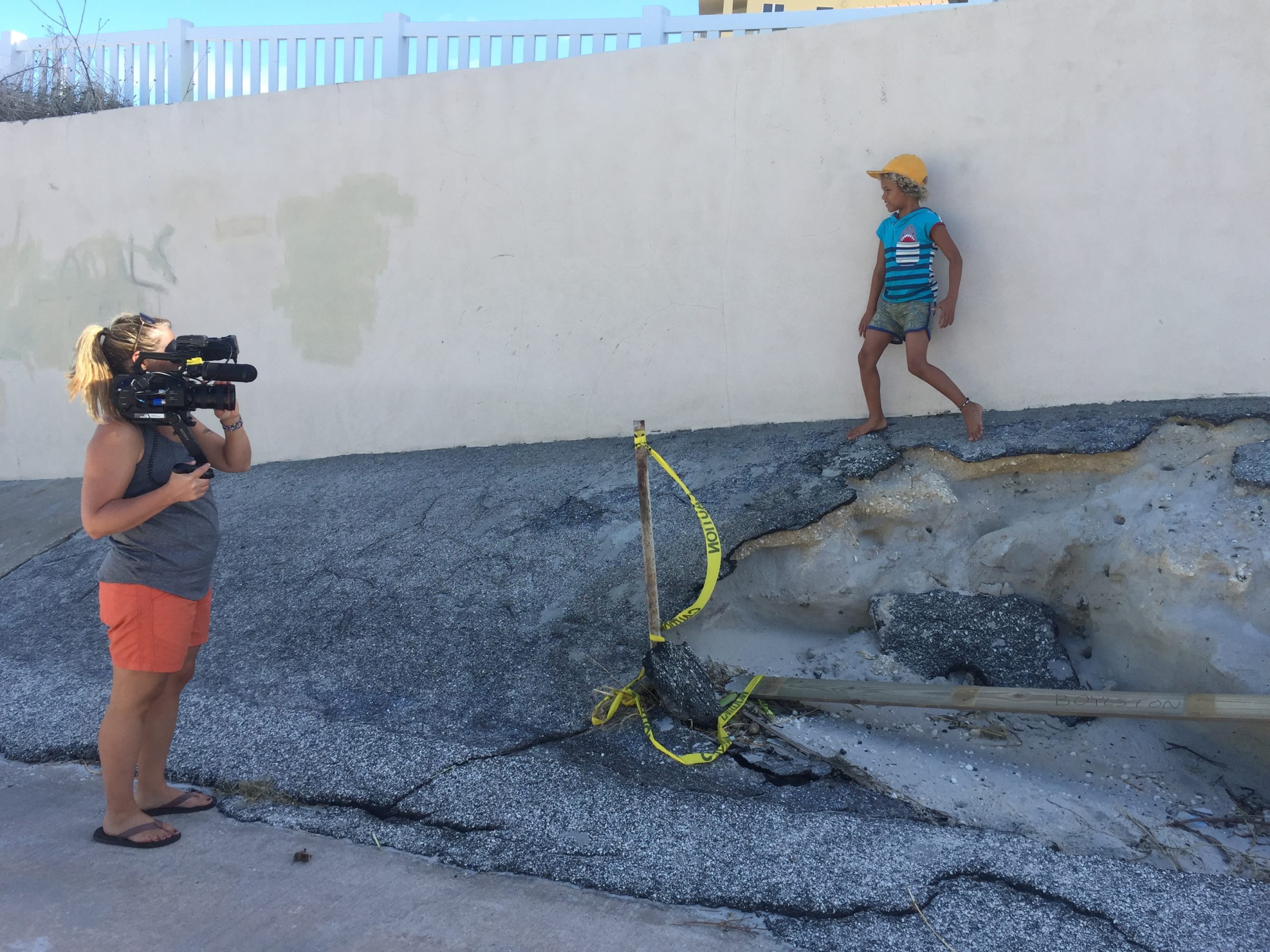 Christi Cooper filming Levi D., a plaintiff in the youth climate change case, near his Florida home after a storm.