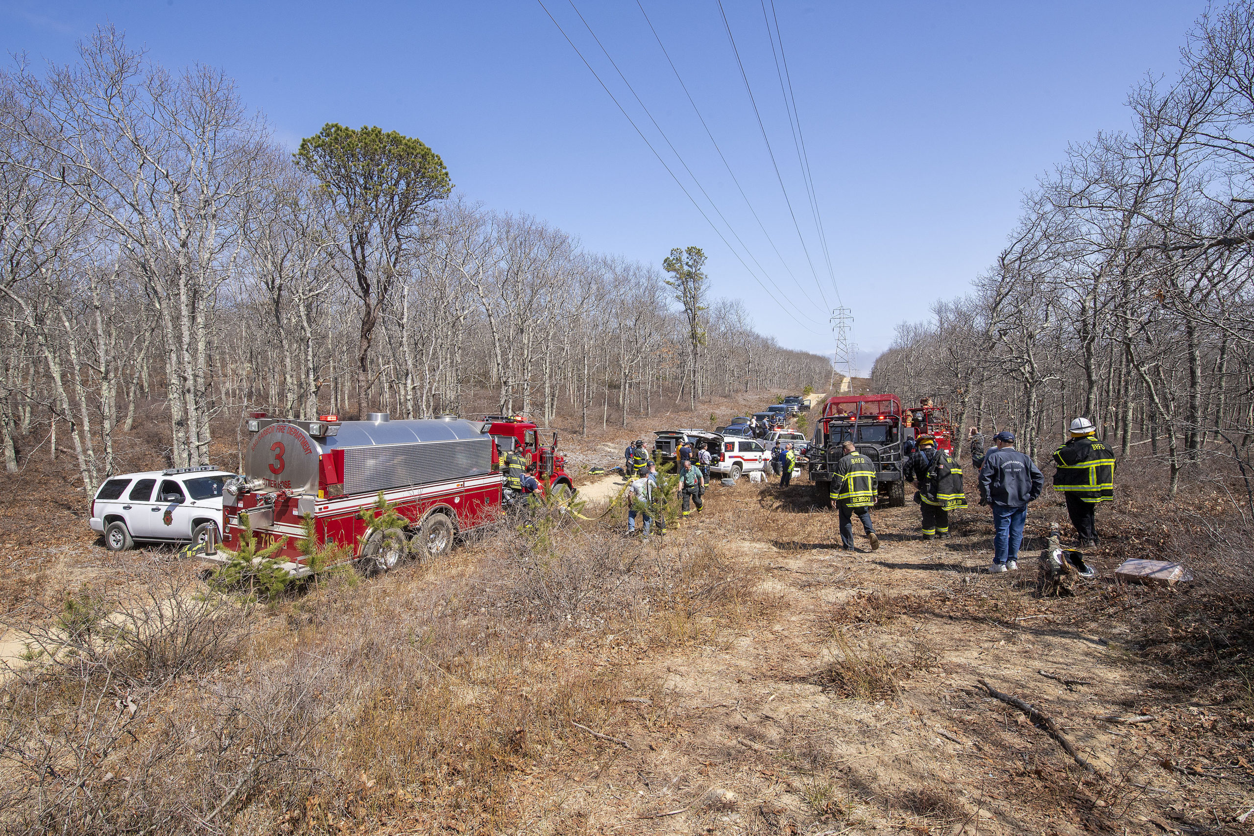 The brush fire was deep in the woods near the power lines.