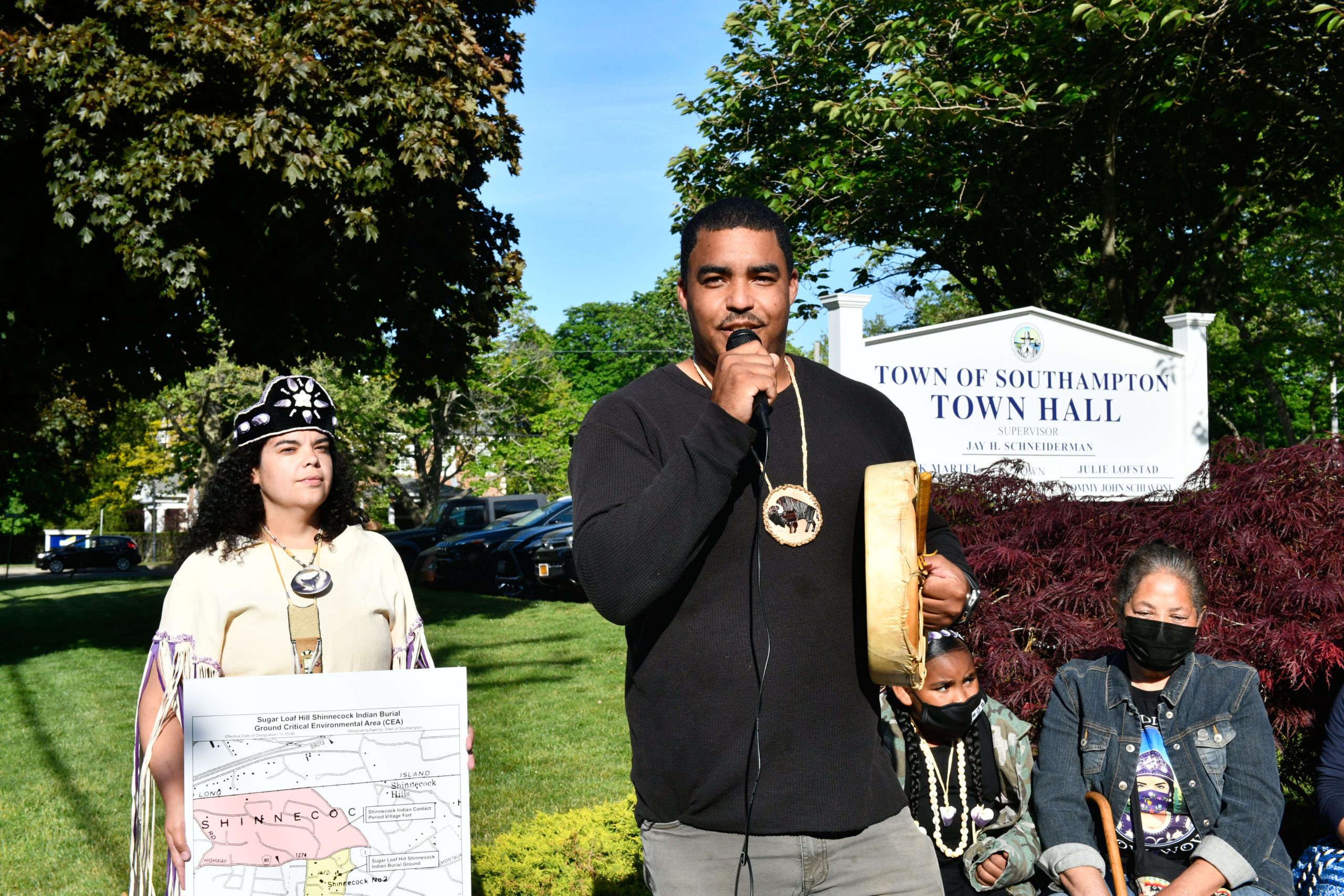 Tela Troge, Shane Week and Rebecca Genia at a rally in front of Southampton Town Hall on Tuesday evening.  DANA SHAW