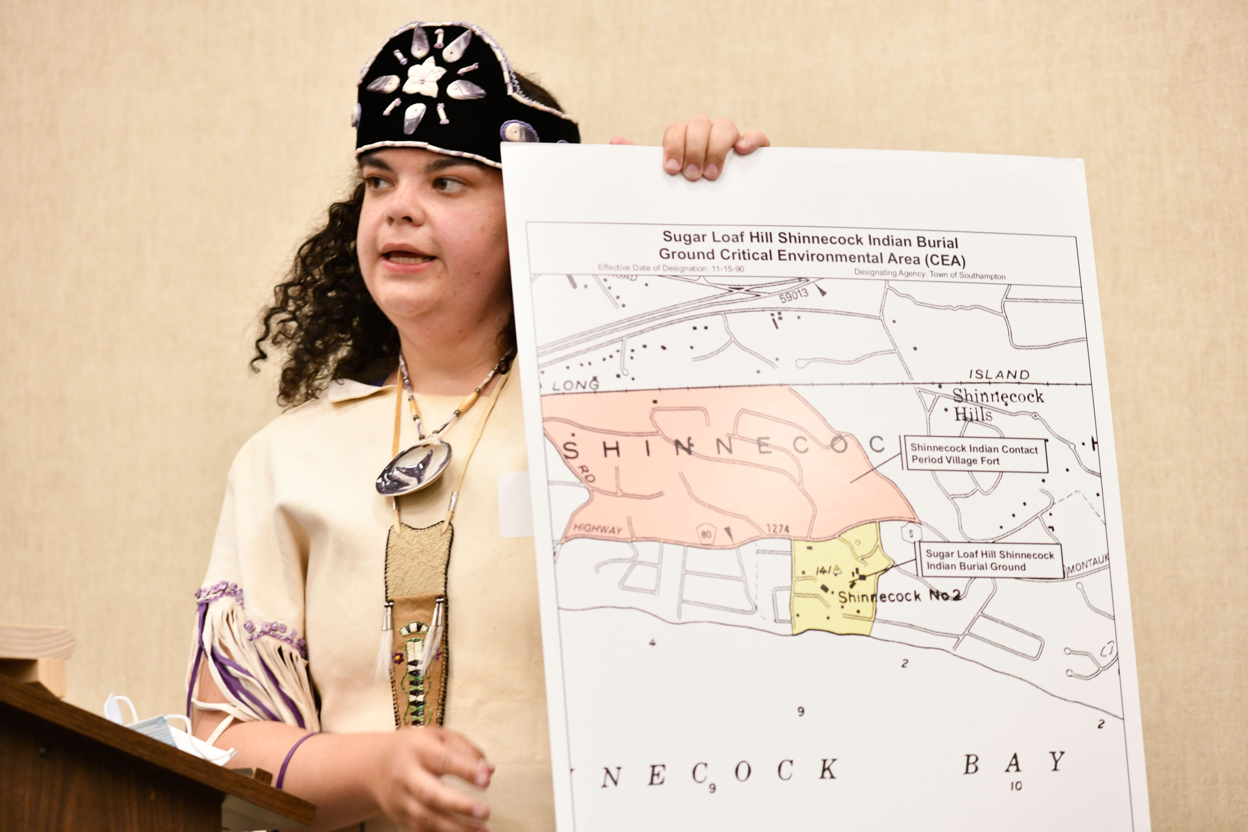 Tela Troge with a map that shows the area in question.  DANA SHAW