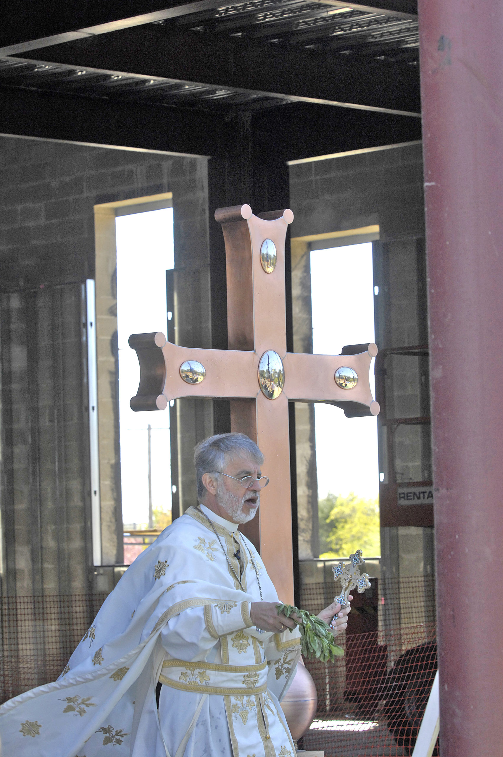 Father Alexander Karloutsos. at the elevation and installation of the Justinian Cross atop the dome of  The Dormition Of The Virgin Mary Church in 2012.