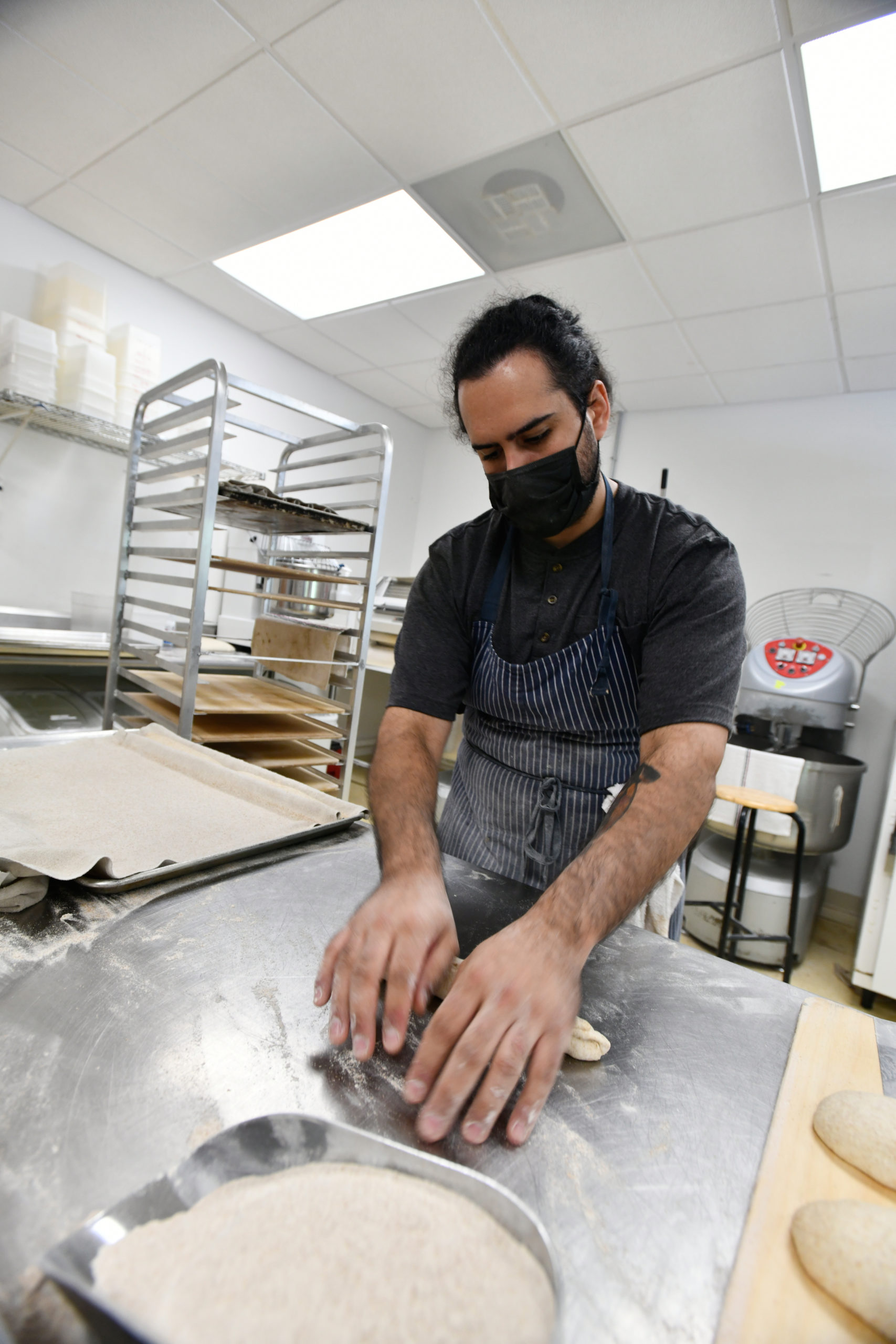 Chef Carlos Barbosa shapes loaves at the Newlight Breadworks kitchen in Calverton.  DANA SHAW