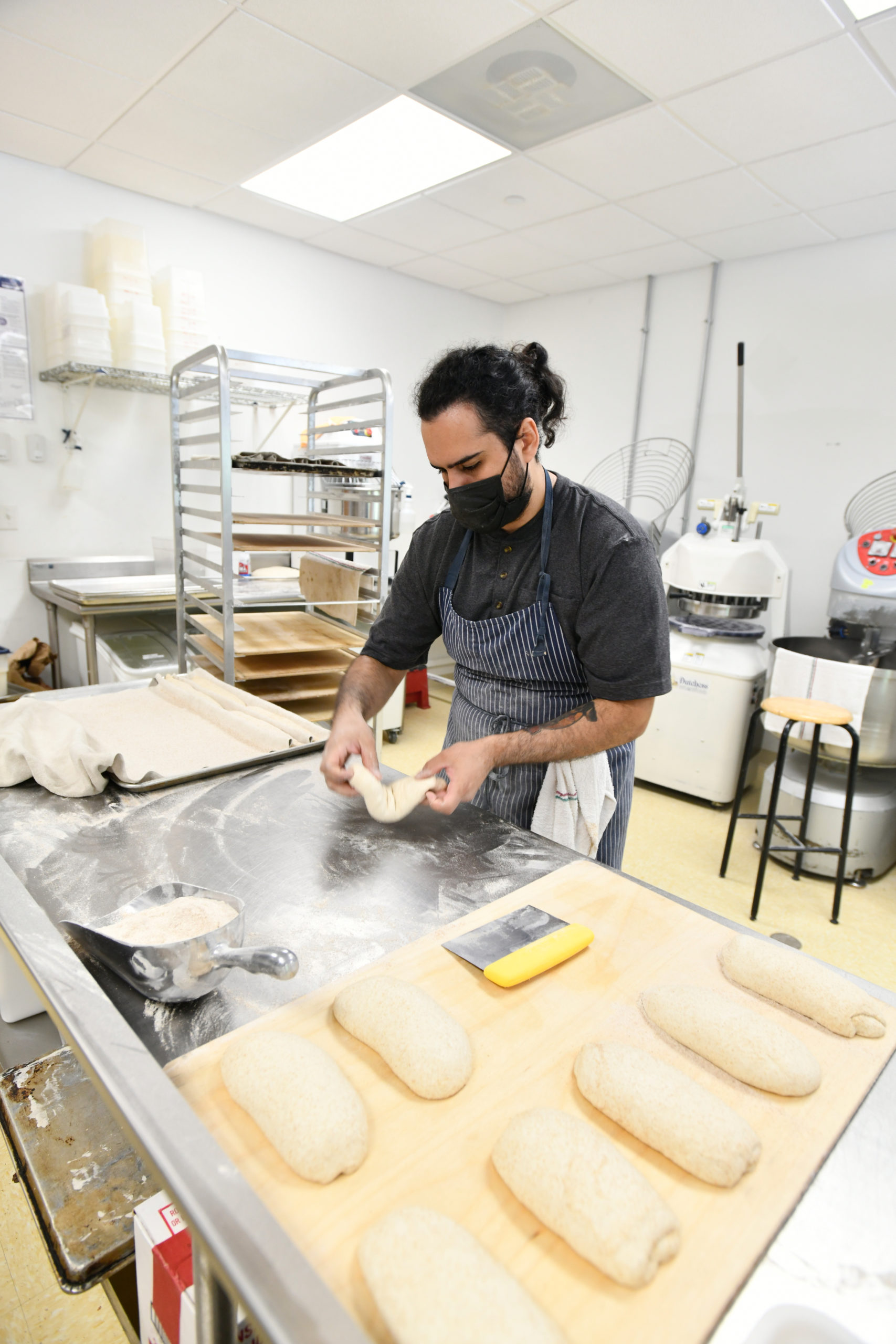 Chef Carlos Barbosa shapes loaves at the Newlight Breadworks kitchen in Calverton.  DANA SHAW