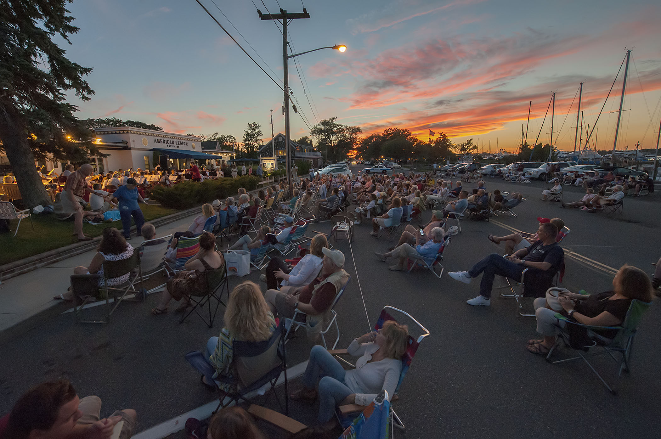 Spectators have traditionally sat on their lawn chairs on Bay Street for Sag Harbor Community Band concerts at the American Legion. MICHAEL HELLER
