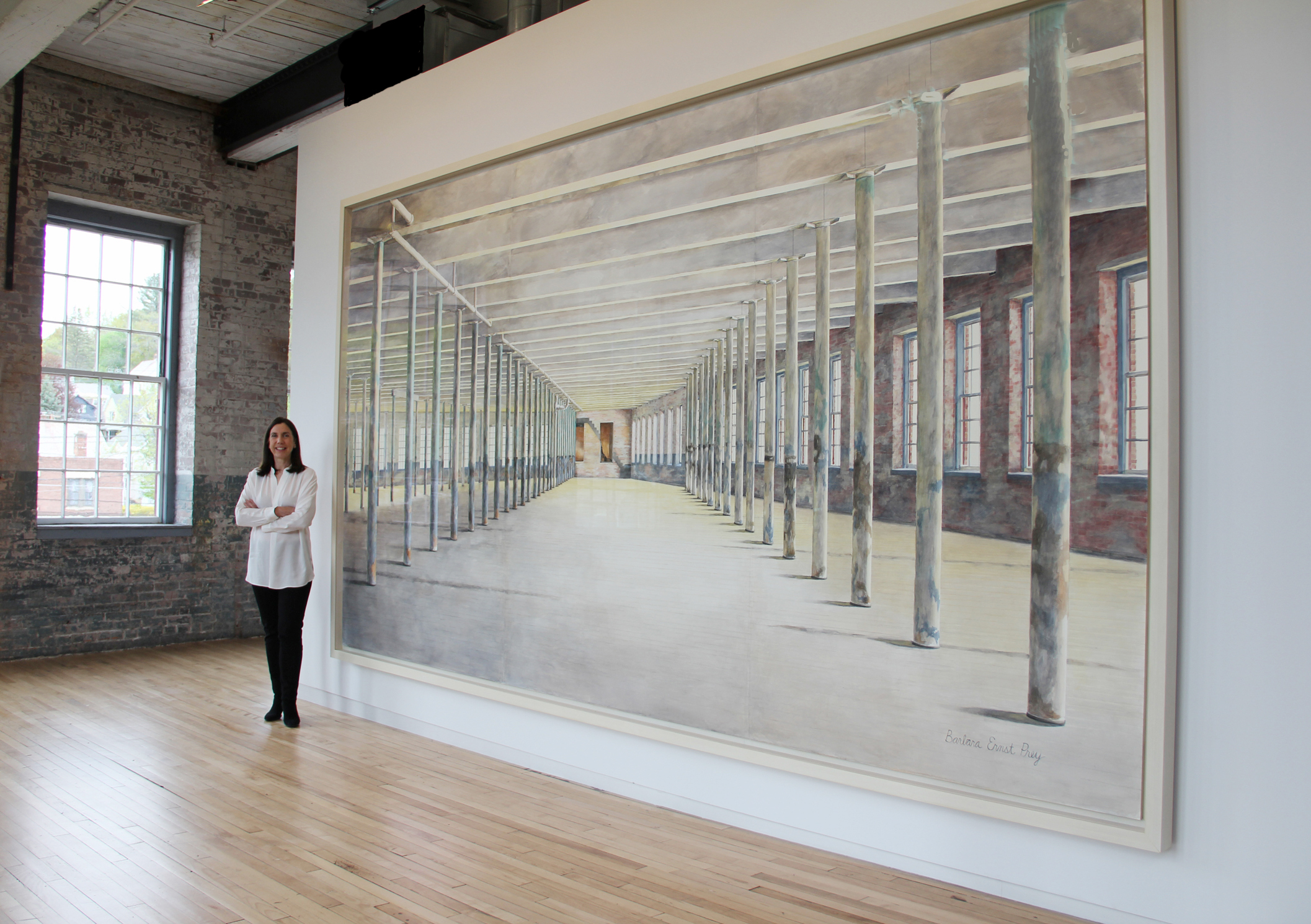 Artist Barbara Prey in front of her finished commission at Mass MoCA, 