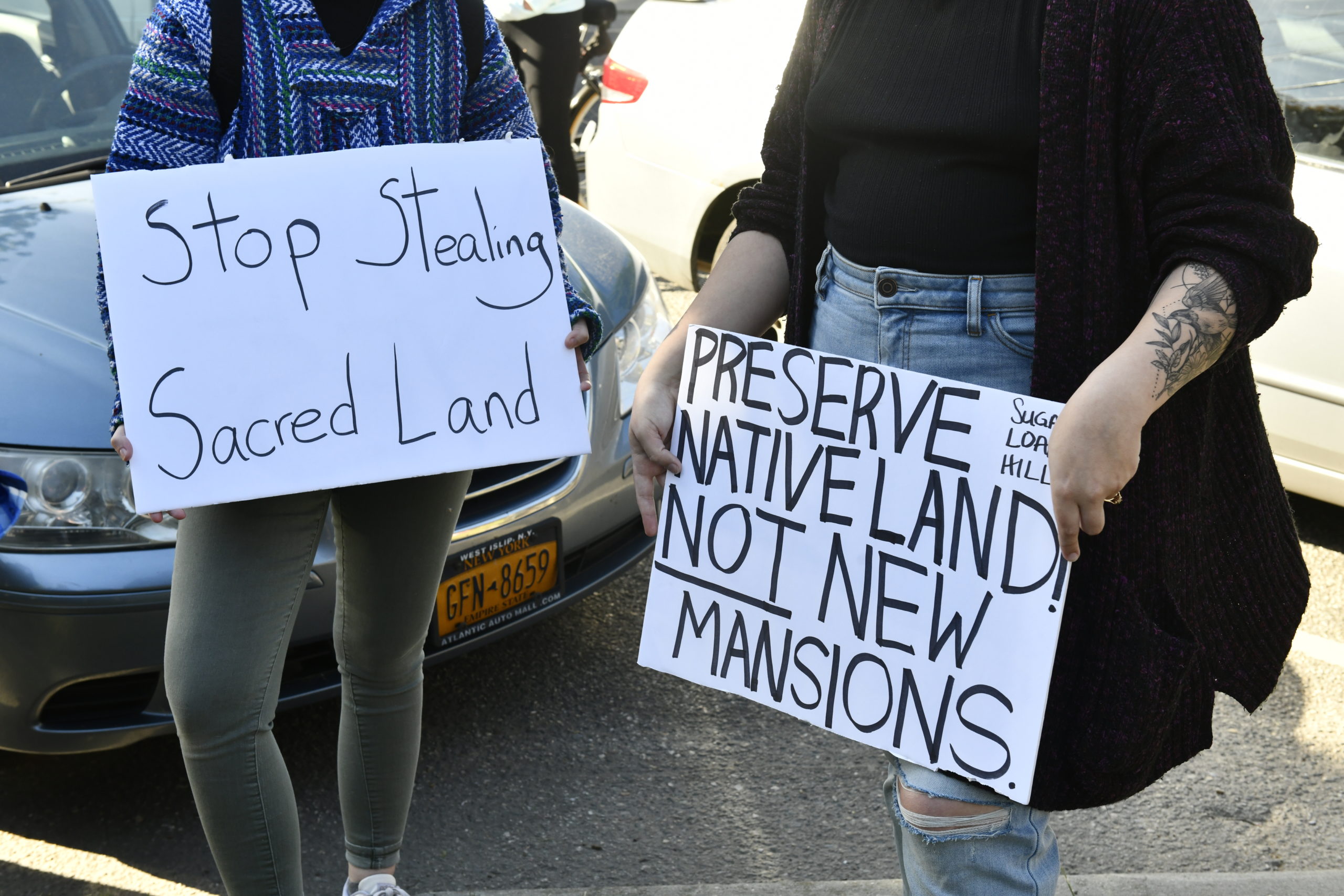 Supporters of the Shinnecock Nation displayed signs calling for the return of land to the tribe. DANA SHAW